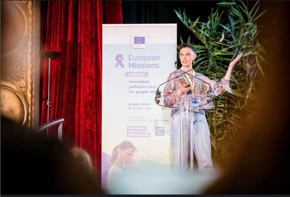 Inna Shchepanska speaking at a lectern during a cancer event